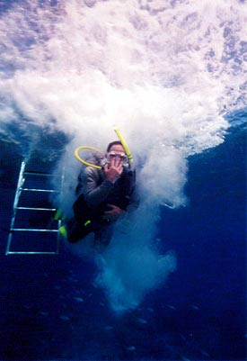 Image from below of diver entering water